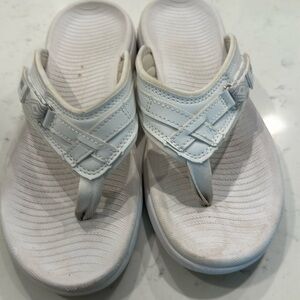 Soft, molded comfortable white flip flops.